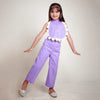 Young girl wearing a purple outfit with a white floral top.